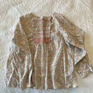 Hand smocked girl’s floral blouse by Bonpoint Paris.